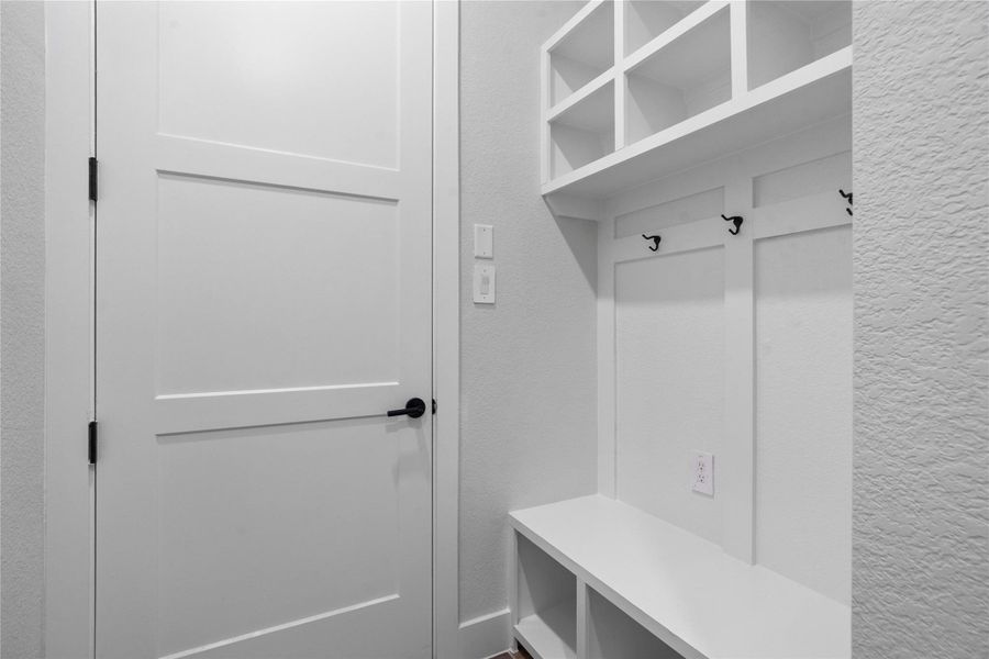This highly functional mud room offers the ultimate in home organization without sacrificing style. Located conveniently near the entry and garage, it provides a seamless transition from the outdoors while keeping the rest of the home clutter-free. With its custom built-ins and durable finishes, it’s a space designed to handle the demands of a busy lifestyle with ease.