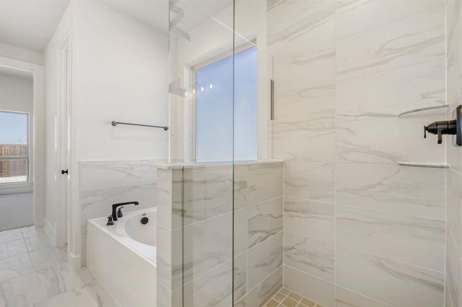Full bathroom with a garden tub, a marble finish shower, and light marble finish floors