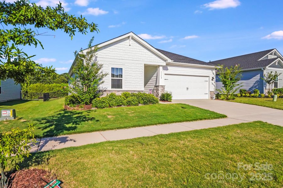 Front exterior of a new home in Simpson Farms, Monroe, NC, highlighting curb appeal (Image 22). Front exterior of a new home in Simpson Farms, Monroe, NC, highlighting curb appeal (Image 22).