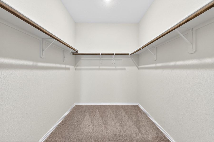 Primary bedroom walk in closet