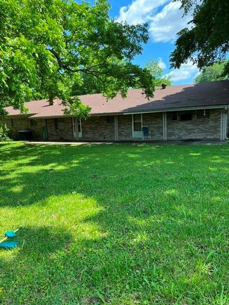 Spacious outdoor area featuring a wide lawn and mature trees providing natural shade Spacious outdoor area featuring a wide lawn and mature trees providing natural shade