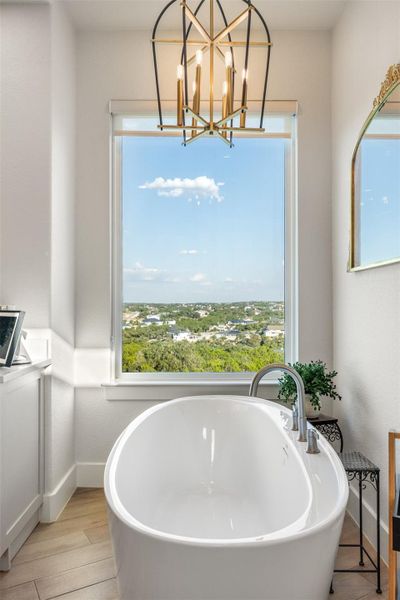 Bathroom with a bathtub and wood-type flooring Bathroom with a bathtub and wood-type flooring