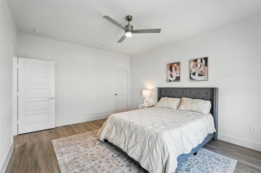 Bedroom with wood finished floors and a ceiling fan