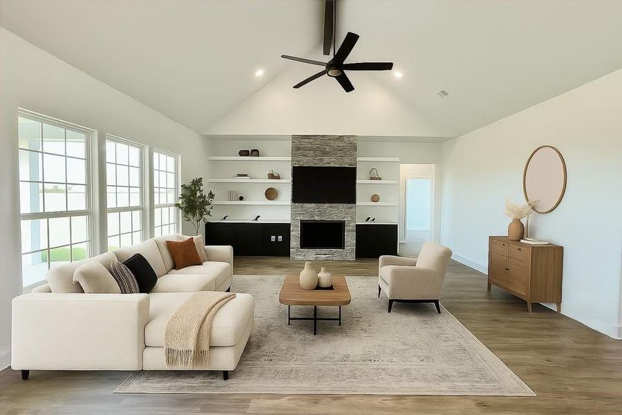 Virtual staging living room with wood finished floors, a large fireplace, a ceiling fan, high vaulted ceiling, and built in shelves Virtual staging living room with wood finished floors, a large fireplace, a ceiling fan, high vaulted ceiling, and built in shelves