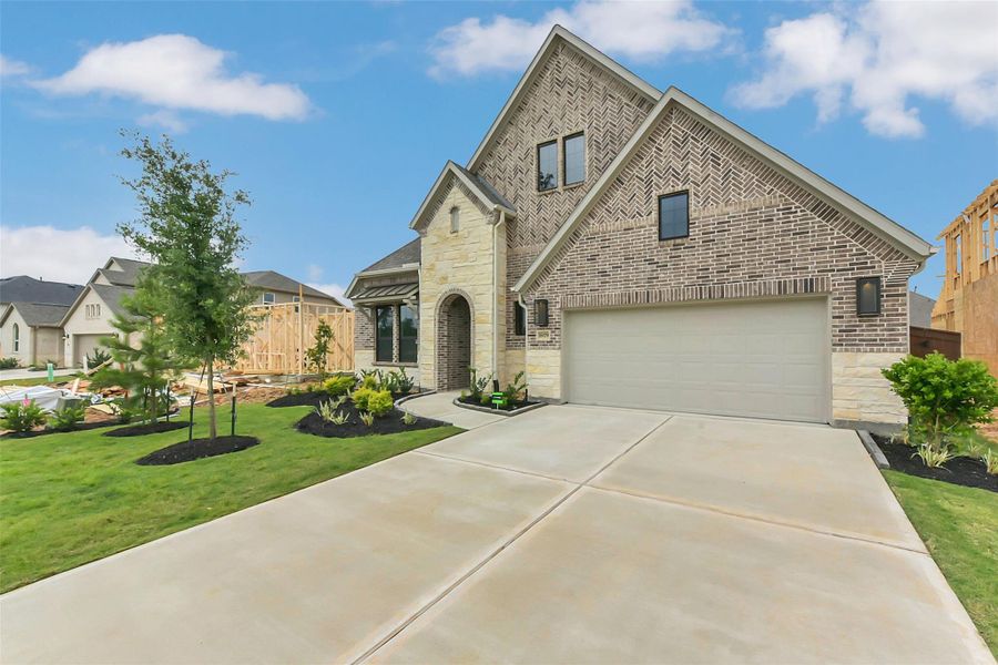 Front exterior of a new home in Evergreen 55', Conroe, TX, highlighting curb appeal (Image 2).