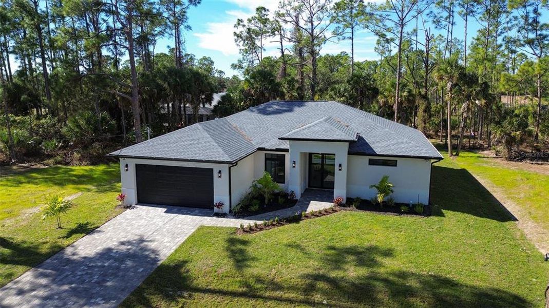 Front exterior of a new home in , North Port, FL, highlighting curb appeal (Image 2). Front exterior of a new home in , North Port, FL, highlighting curb appeal (Image 2).
