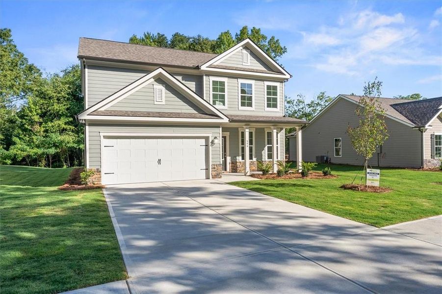 Front exterior of a new home in Ellington Farms, Statham, GA, highlighting curb appeal (Image 2). Front exterior of a new home in Ellington Farms, Statham, GA, highlighting curb appeal (Image 2).