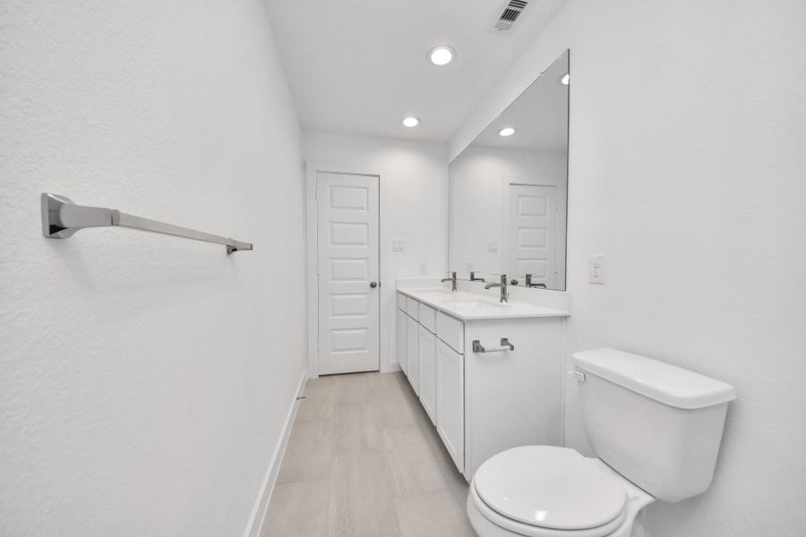 Secondary bath features tile flooring, bath/shower combo with tile surround, light stained wood cabinets, beautiful light countertop. Sample photo of completed home with similar floor plan. Actual colors and selections may vary. Secondary bath features tile flooring, bath/shower combo with tile surround, light stained wood cabinets, beautiful light countertop. Sample photo of completed home with similar floor plan. Actual colors and selections may vary.