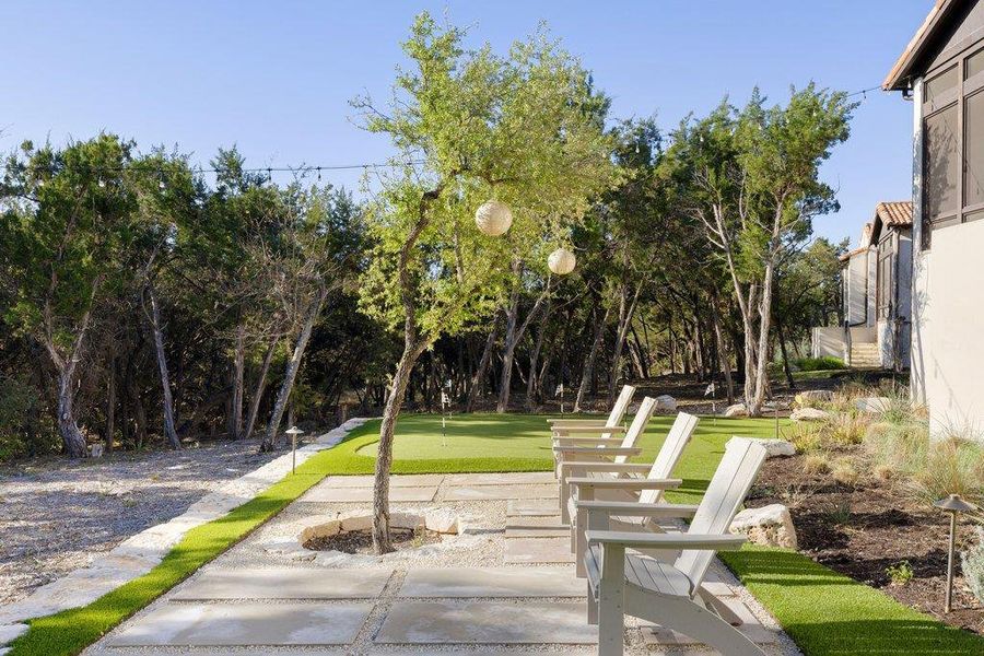 View of community with a putting green and a patio area