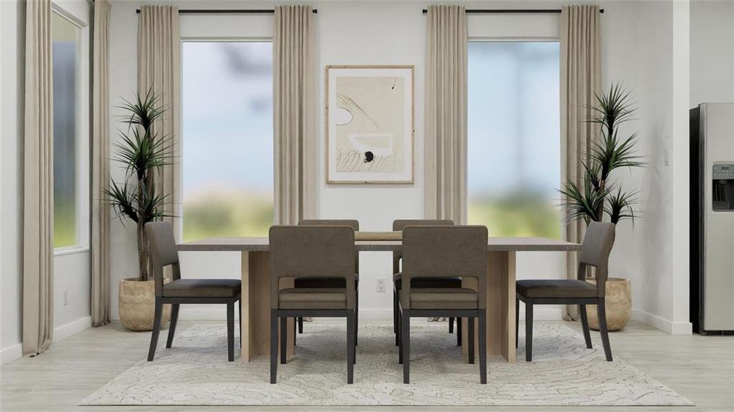 Dining area with light wood-style floors Dining area with light wood-style floors