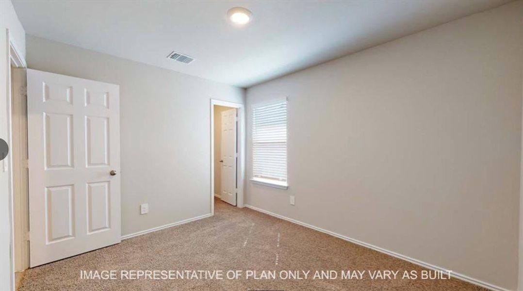 Unfurnished bedroom featuring light carpet and baseboards