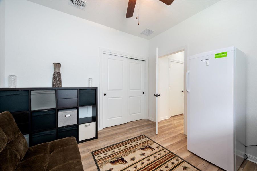 Sitting room with ceiling fan and light wood-style floors Sitting room with ceiling fan and light wood-style floors