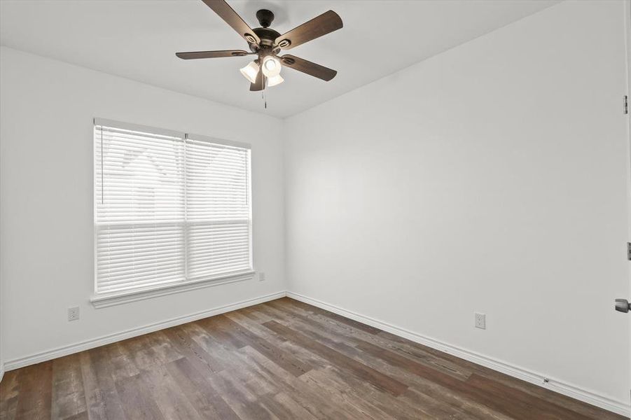 Spare room featuring hardwood / wood-style floors and ceiling fan