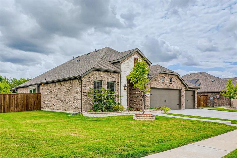 French country style house with a garage and a front yard