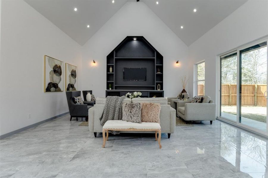 Bedroom featuring high vaulted ceiling and access to exterior