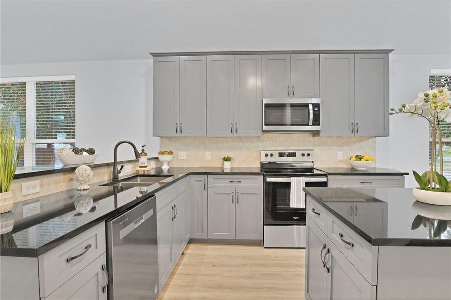 Kitchen with stainless steel sink and dishwasher.