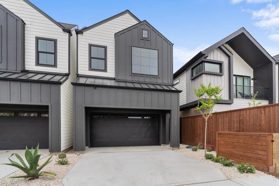 Exterior features include a two-car garage with custom cabinetry by GoBravura and a 5’ porte-cochere for added convenience. Exterior features include a two-car garage with custom cabinetry by GoBravura and a 5’ porte-cochere for added convenience.