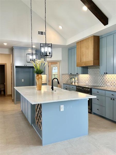 Kitchen featuring gray cabinetry, tasteful backsplash, a spacious island, pendant lighting, and recessed lighting