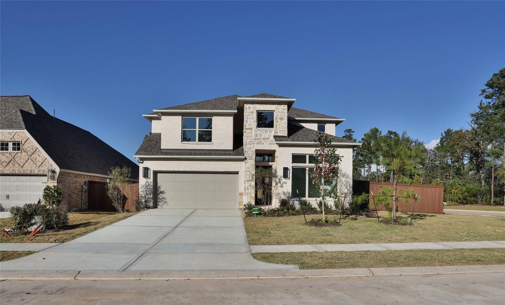 Front exterior of a new home in Evergreen 50', Conroe, TX, highlighting curb appeal (Image 1).