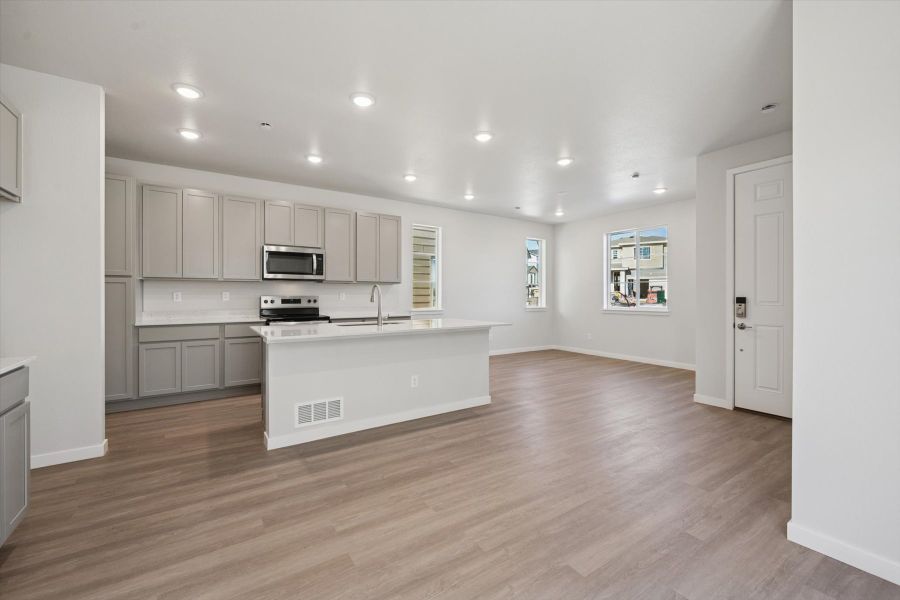 A kitchen with white cabinets.