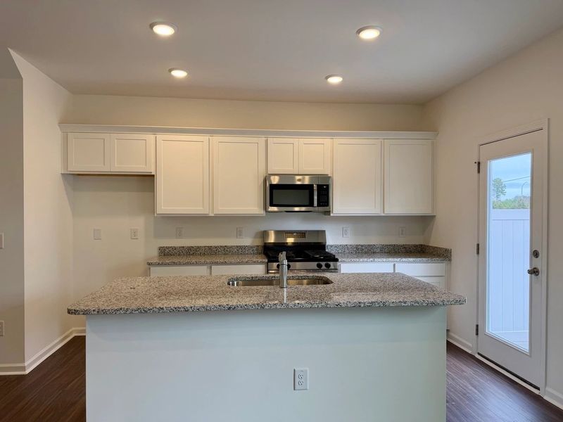 Kitchen - Chic white finishes and smooth surfaces shine.