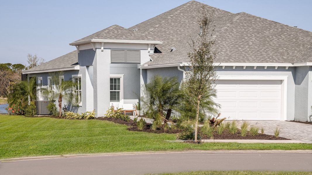 Front exterior of a new home in Wildleaf at North River Ranch, Parrish, FL, highlighting curb appeal (Image 17). Front exterior of a new home in Wildleaf at North River Ranch, Parrish, FL, highlighting curb appeal (Image 17).