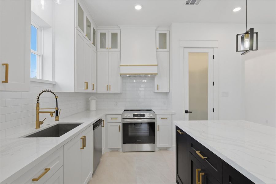Chef’s kitchen fully equipped and ready for use! Find a walk in pantry, oversized kitchen island, custom cabinetry and a stainless steel stove ready for its debut