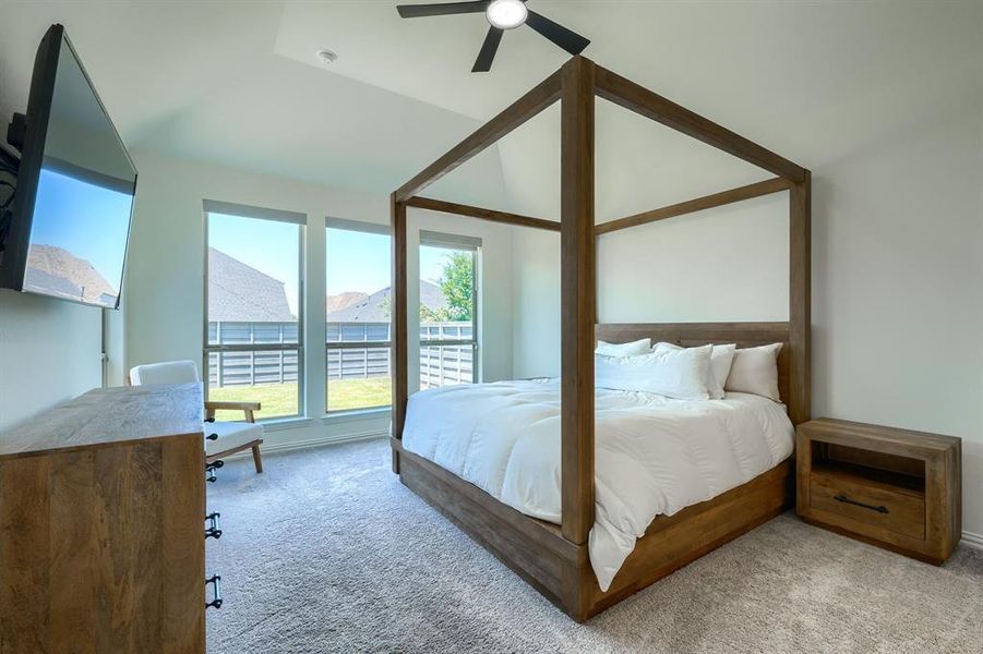 Primary bedroom featuring lots of natural light & ceiling fan