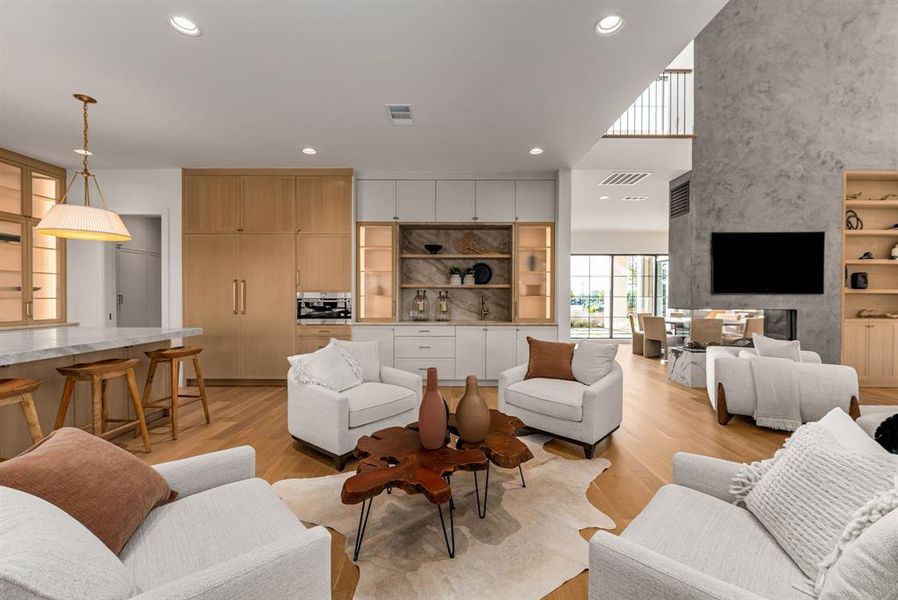 Living area with recessed lighting and light wood-type flooring