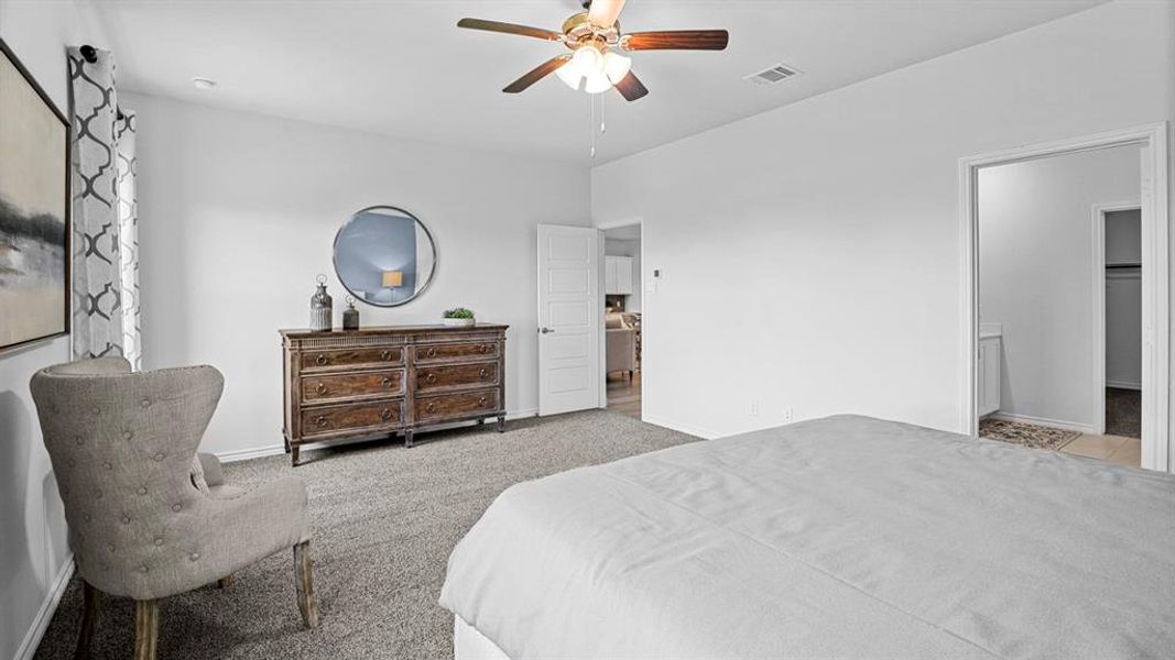 Bedroom featuring light colored carpet and a ceiling fan