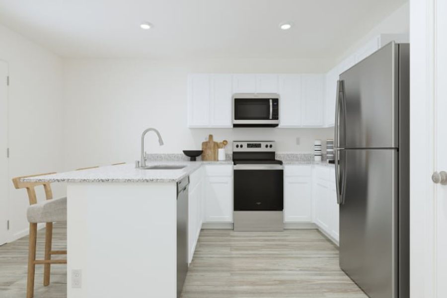 A kitchen with white cabinets.