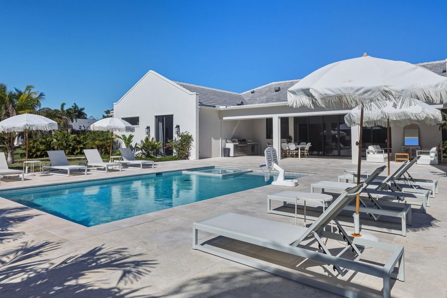 Incredible resort-style backyard surrounded by coconut trees & expansive lawn