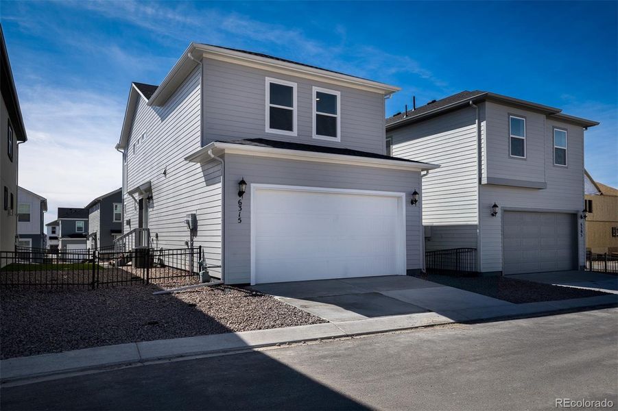 Exterior details and patio area of a home in Revel Crossing at Wolf Ranch – The Ascent Collection, Colorado Springs (Image 1).