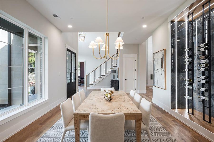 Dining area featuring an inviting chandelier and hardwood / wood-style floors