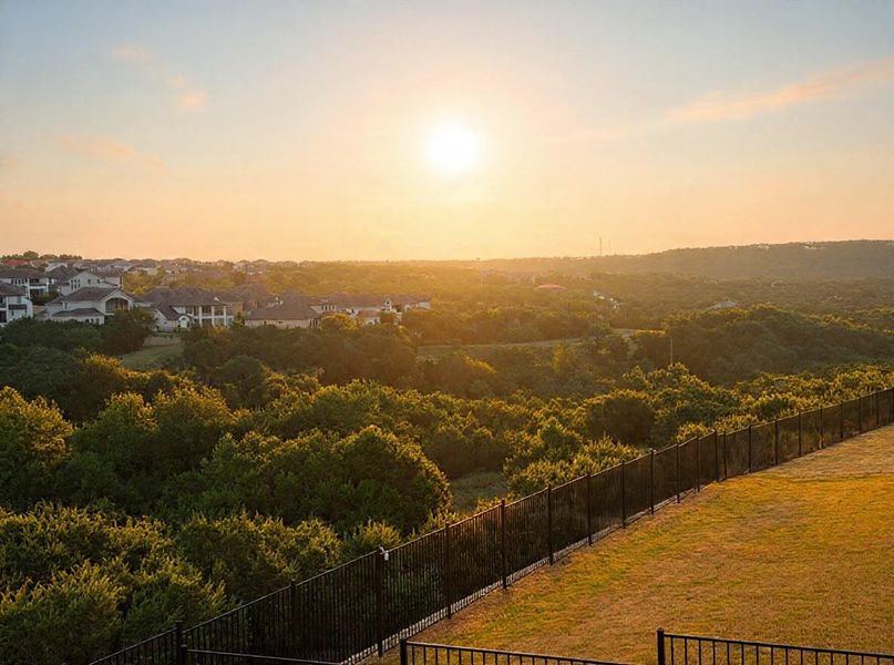 Golden hour illuminates the sprawling landscape and distant residential rooftops.