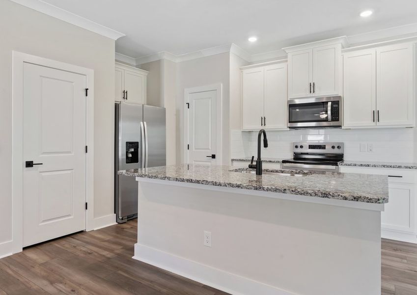 The kitchen has designer wood cabinetry