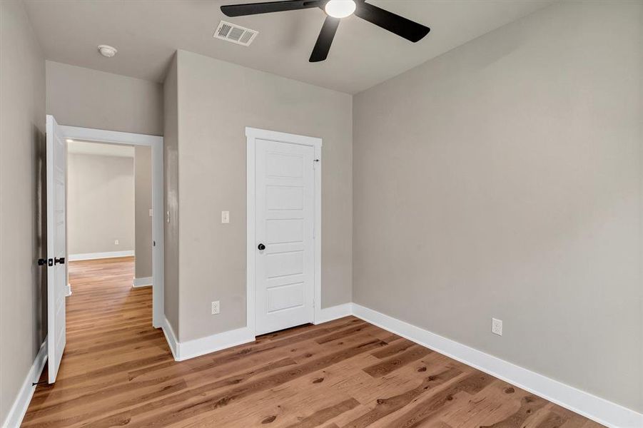 Unfurnished bedroom featuring light wood finished floors, a closet, and ceiling fan Unfurnished bedroom featuring light wood finished floors, a closet, and ceiling fan