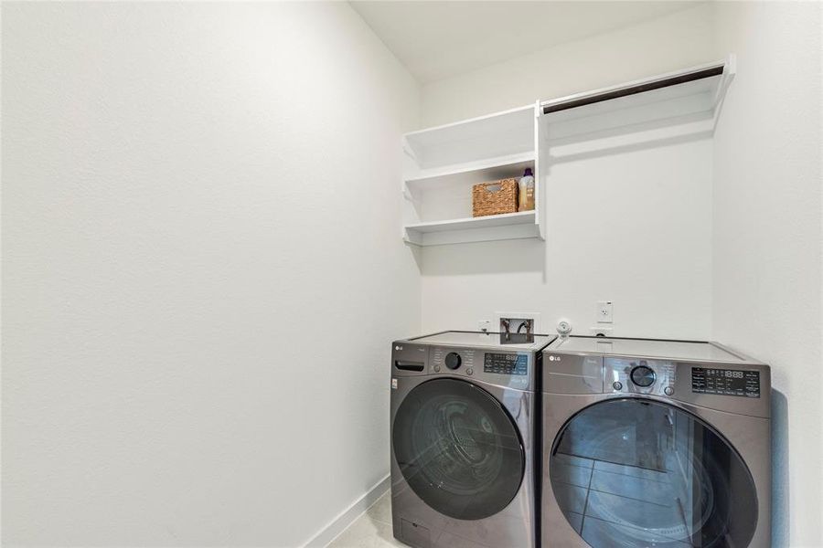 Large laundry room space with washer/dryer installed.