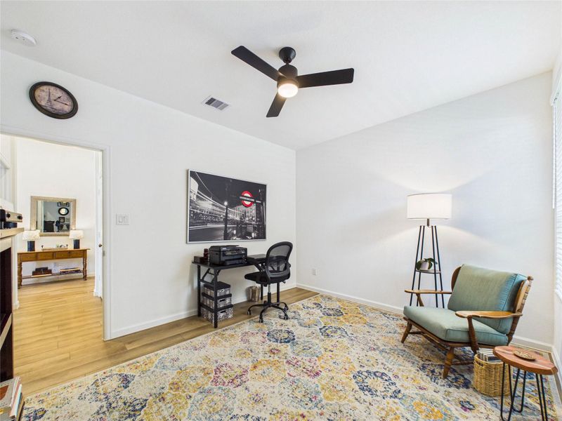 This secondary bedroom is currently being used as a workspace, but offers LVP flooring, ceiling fan and walk-in closet.
