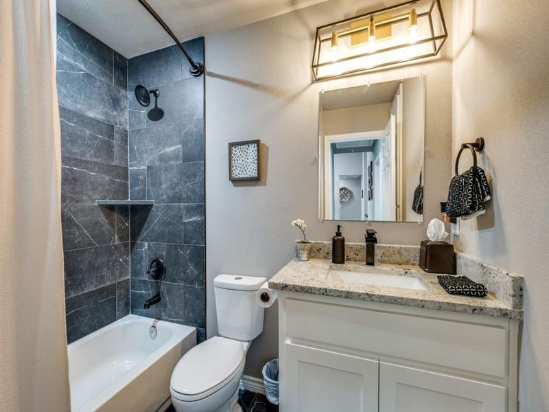 Full bath with vanity, shower / tub combo, and toilet Full bath with vanity, shower / tub combo, and toilet