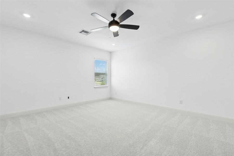 Empty room featuring carpet floors, recessed lighting, and a ceiling fan Empty room featuring carpet floors, recessed lighting, and a ceiling fan