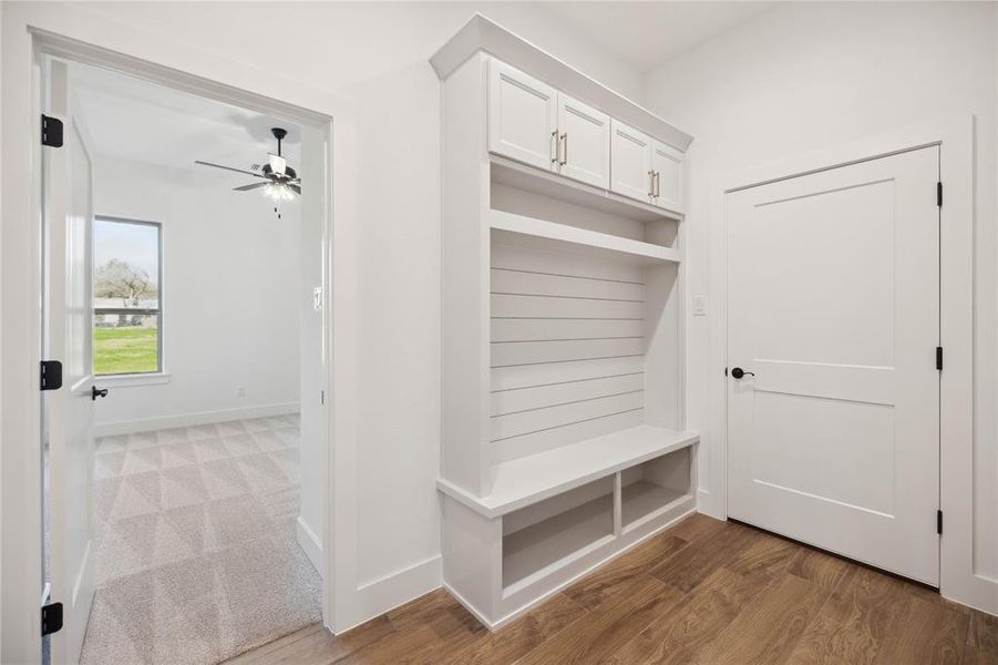 Mudroom with wood-type flooring and ceiling fan