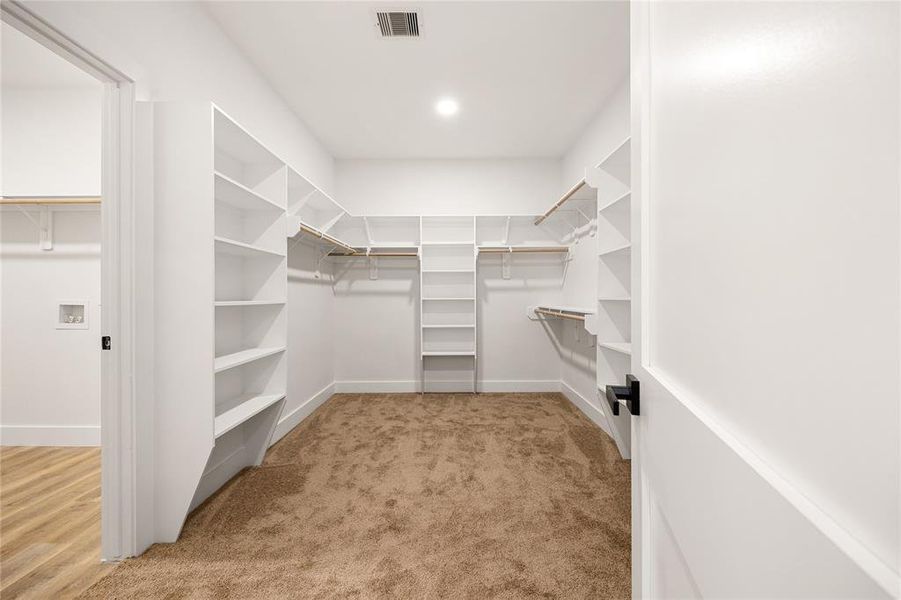 Spacious Walk-In ClosetThis expansive walk-in closet offers ample storage with built-in shelving, hanging rods, and a thoughtfully designed layout. Perfect for organizing your wardrobe with ease while maintaining a clean and stylish look!