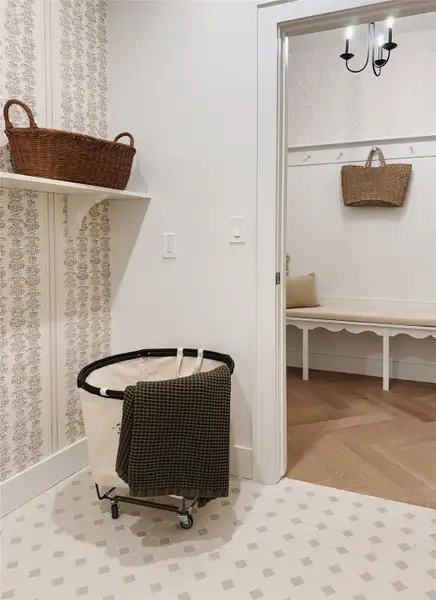 Patterned custom french hexagonal floor tiles complement the decorative wallpaper and a built-in shelf which opens up to the mud room with built-in bench and designer wall paper Patterned custom french hexagonal floor tiles complement the decorative wallpaper and a built-in shelf which opens up to the mud room with built-in bench and designer wall paper