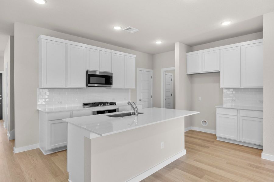 Kitchen in the Magnolia home plan by Trophy Signature Homes – REPRESENTATIVE PHOTO Kitchen in the Magnolia home plan by Trophy Signature Homes – REPRESENTATIVE PHOTO