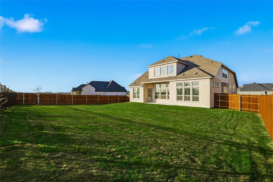 Back of house featuring a fenced backyard and a patio area Back of house featuring a fenced backyard and a patio area
