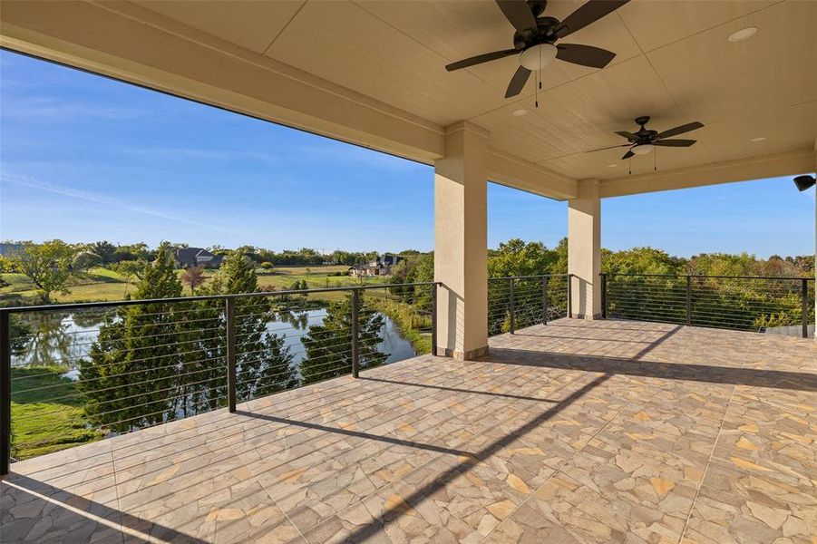 View of patio / terrace featuring a water view, a balcony, and ceiling fan