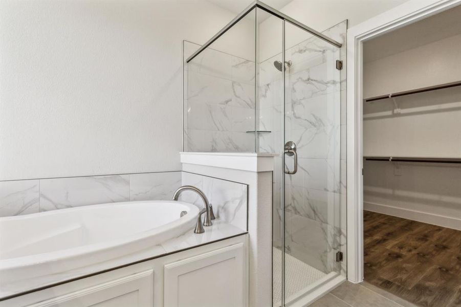Bathroom with wood-type flooring and separate shower and tub