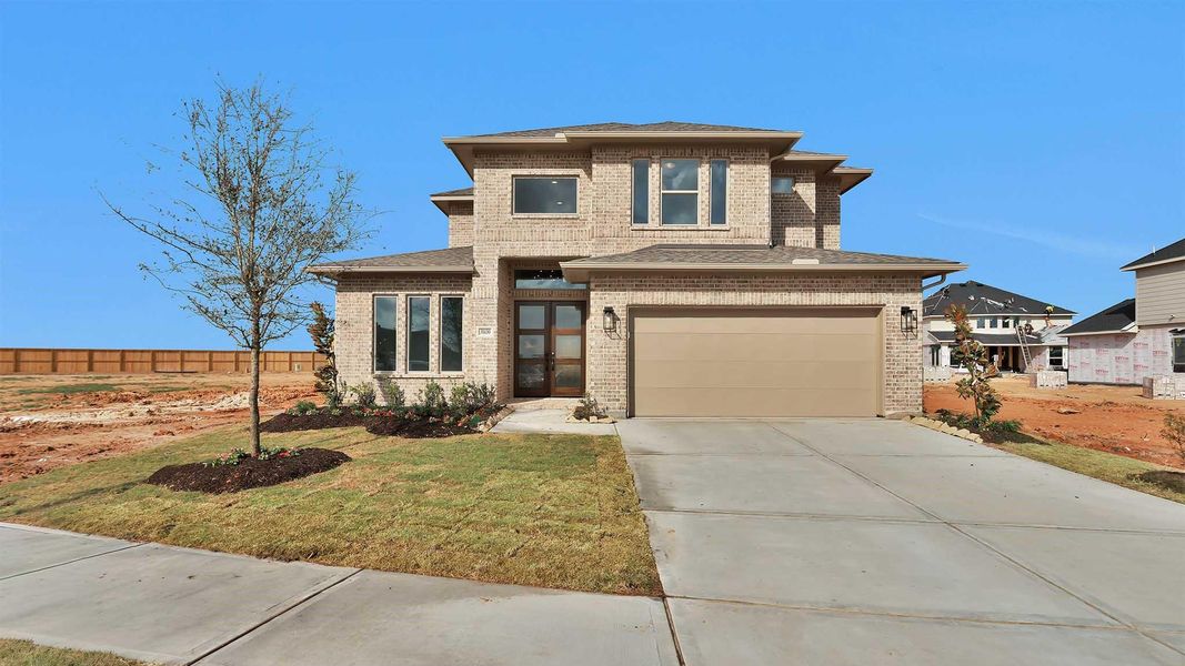 Front exterior of a new home in Jordan Ranch, Fulshear, TX, highlighting curb appeal (Image 2). Front exterior of a new home in Jordan Ranch, Fulshear, TX, highlighting curb appeal (Image 2).