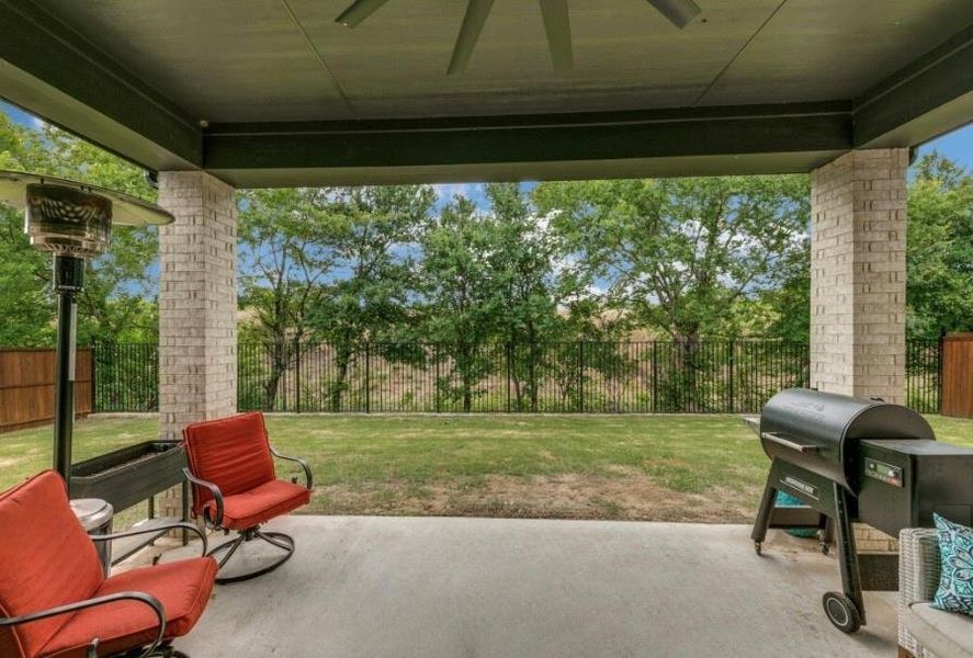 View of patio featuring a grill and ceiling fan